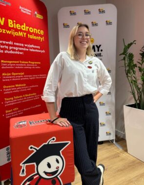 Жанчына на фоне банераў з лагатыпам Biedronka.