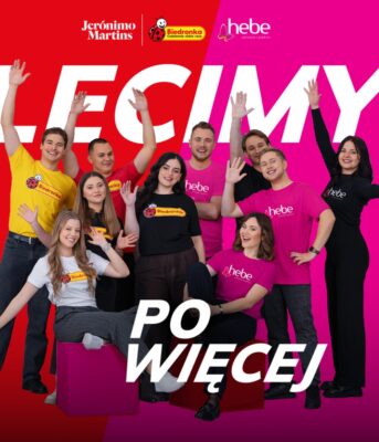 Smiling people waving at the camera. The caption reads: We're coming for more.