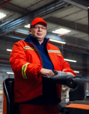 Pracownik centrum dystrybucyjnego biedronki na wózku widłowym.